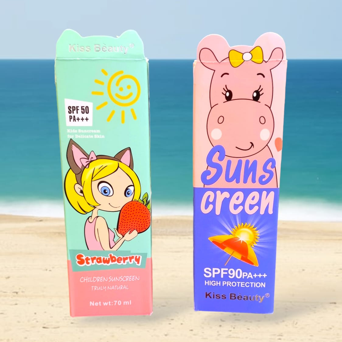 Dos protectores solares Kiss Beauty en caja con diseño infantil de playa: uno de fresa SPF 50 y otro de hipopótamo SPF 90.