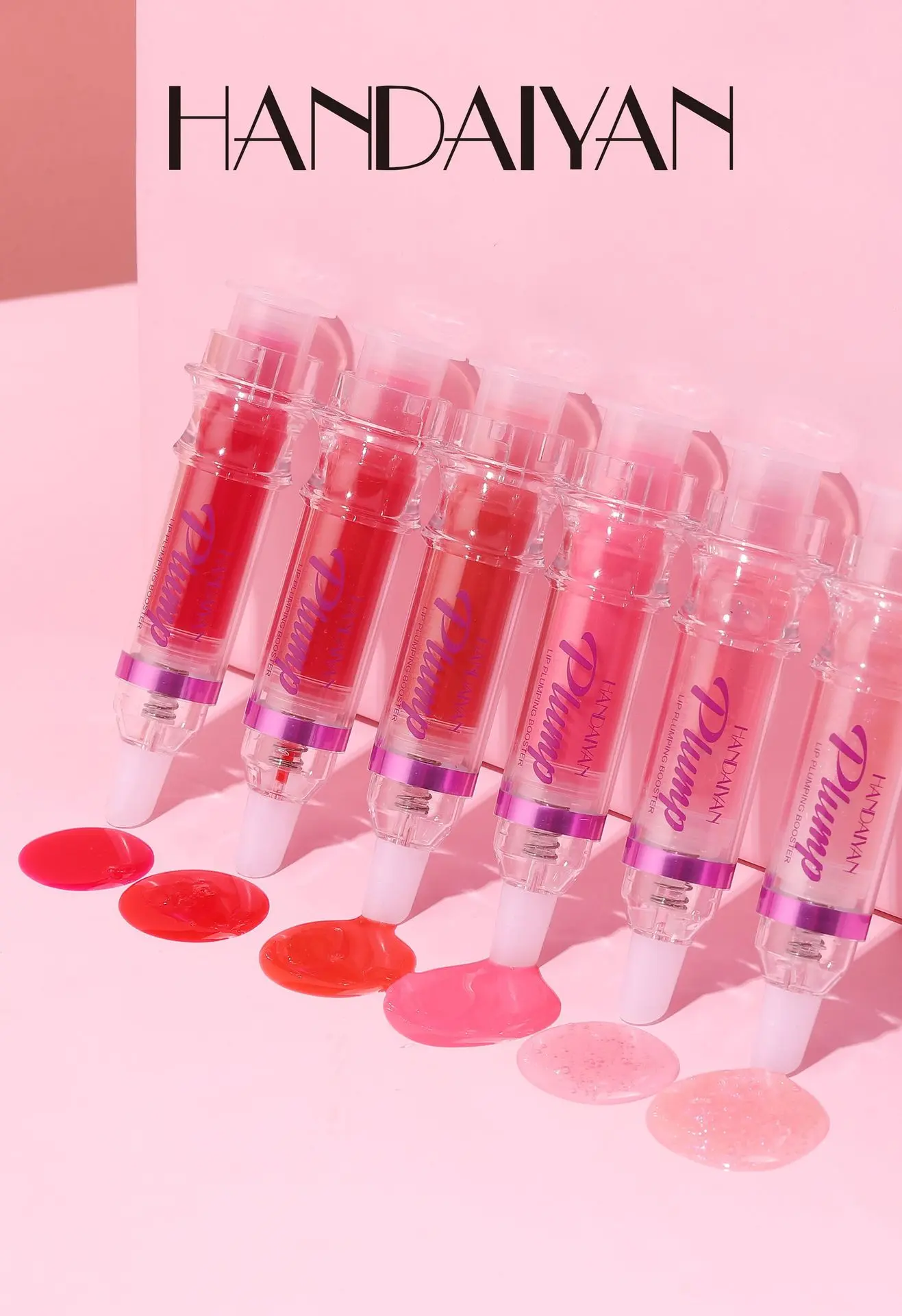 Voluminizador de labios HANDAIYAN en forma de jeringa, varios tonos rosados y rojos, brillo líquido y textura suave.