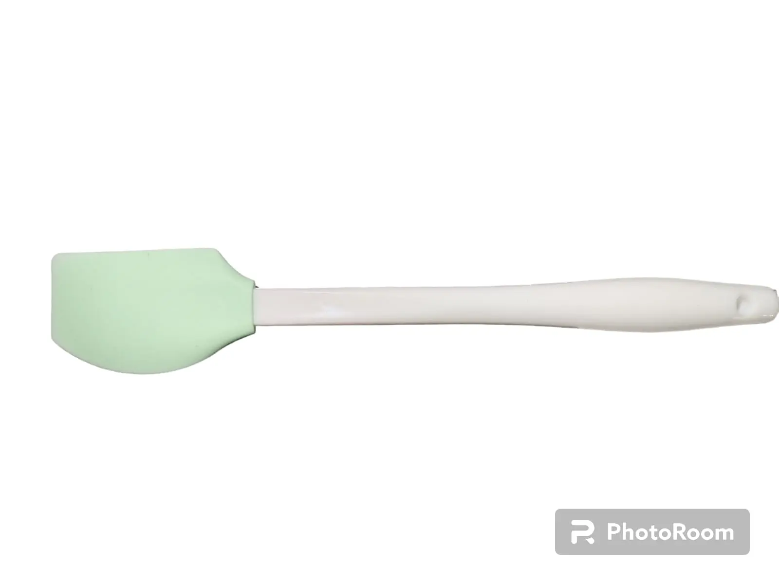 Espátula de cocina con cabezal de silicona color verde claro y mango ergonómico blanco, ideal para repostería y mezcla de ingredientes.