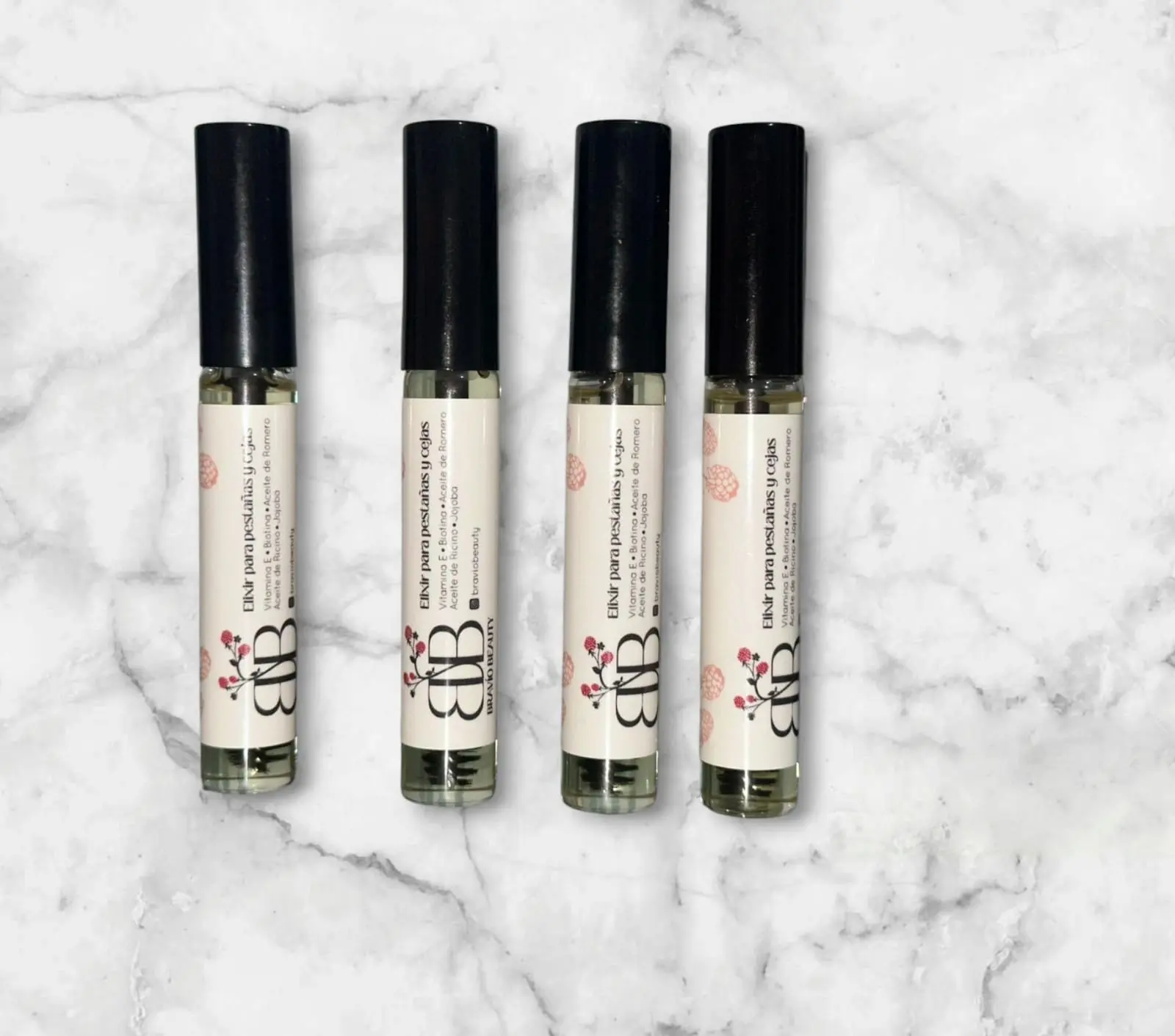 Serum elixir para pestañas y cejas con vitamina E, biotina y aceites de ricino y jojoba, en envases pequeños.