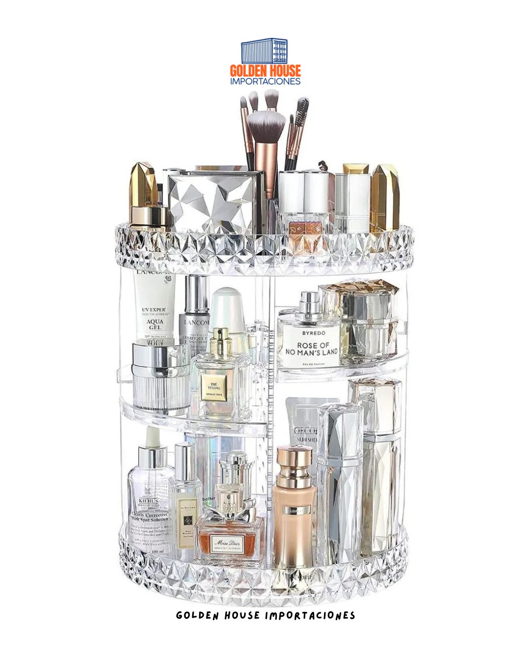 Organizador de maquillaje giratorio de acrílico transparente con botellas de perfume y brochas.