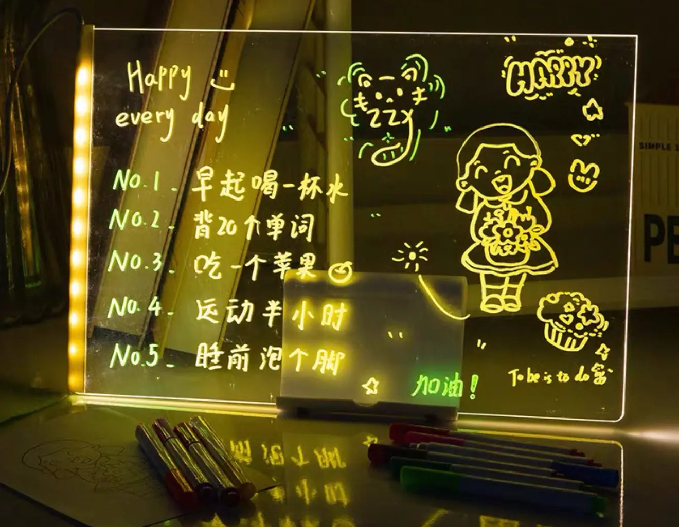 Tablero acrílico luminoso con mensajes y dibujos, ideal para escribir tareas o recordatorios diarios.