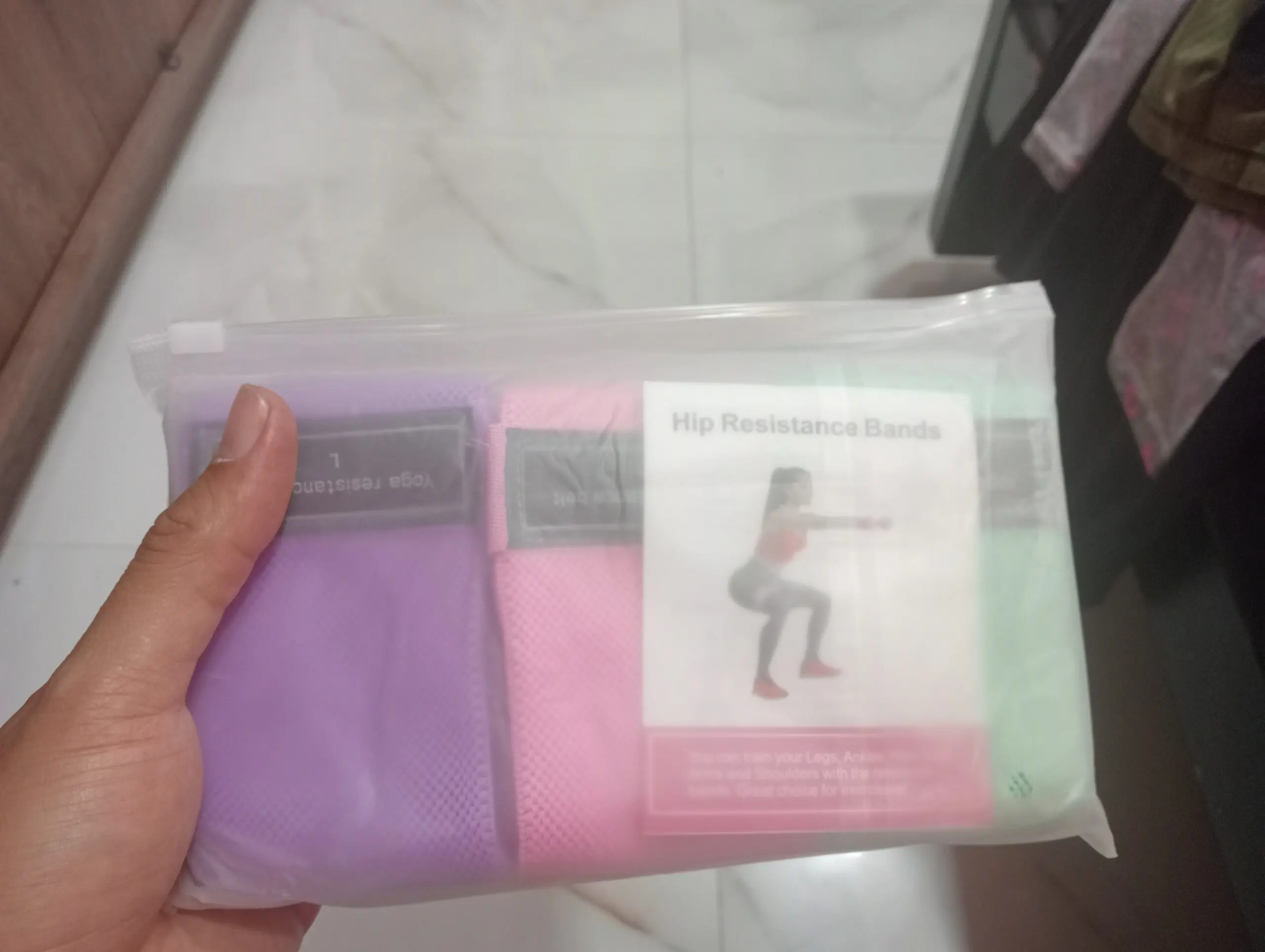 Bandas de resistencia para caderas en tela, talla L, morado y rosa, en empaque transparente.