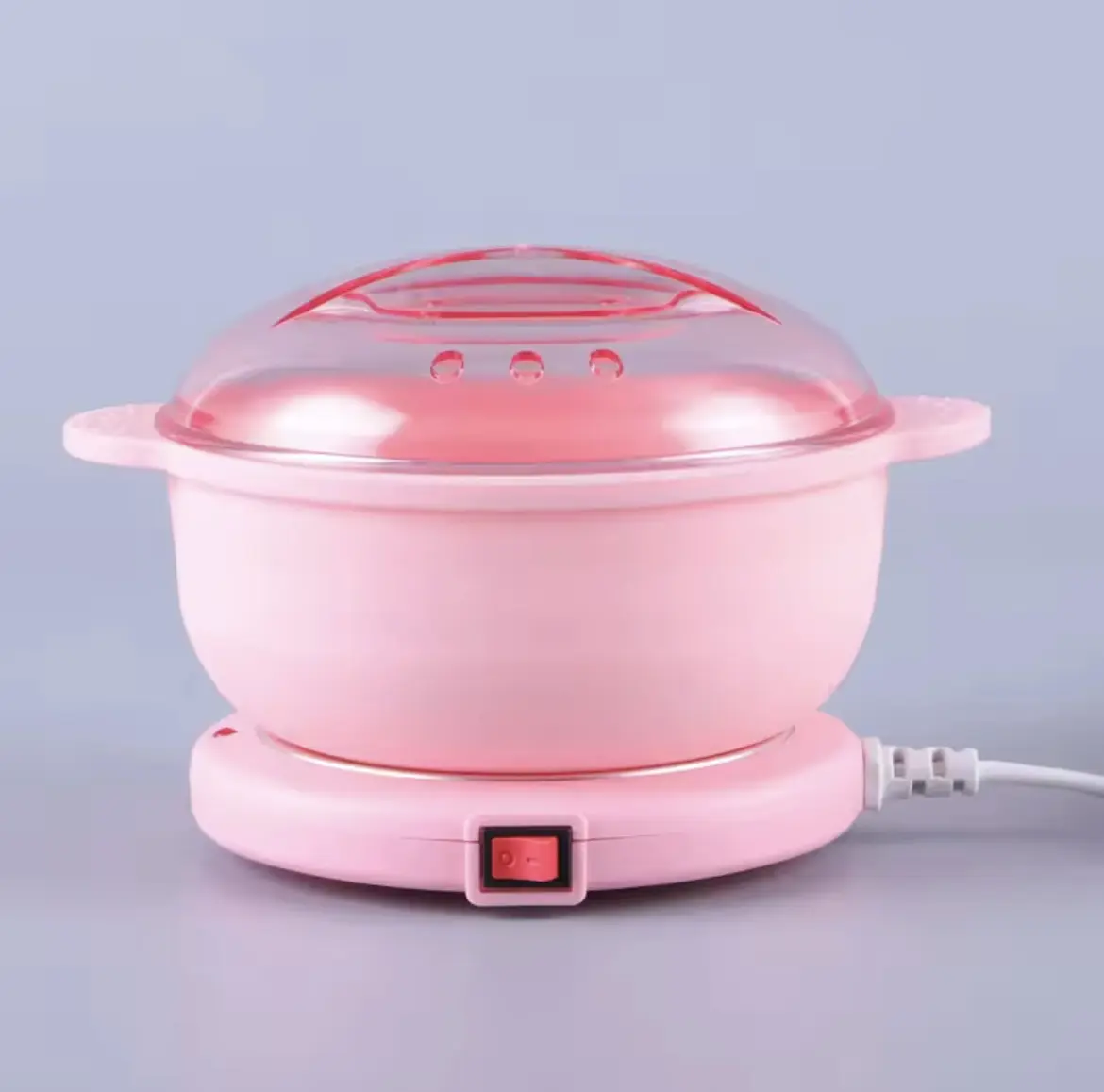 Olla rosada calentadora de cera depilatoria con tapa transparente y control de encendido.