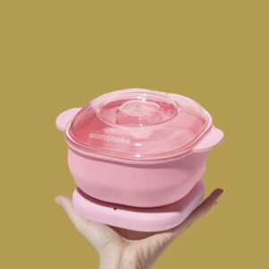 Olla calentadora de cera depilatoria rosa, plegable y portátil, sostenida en mano.
