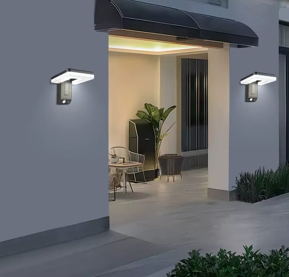 Lámpara solar de pared LED exterior gris, con sensor de movimiento, ilumina entrada de casa.