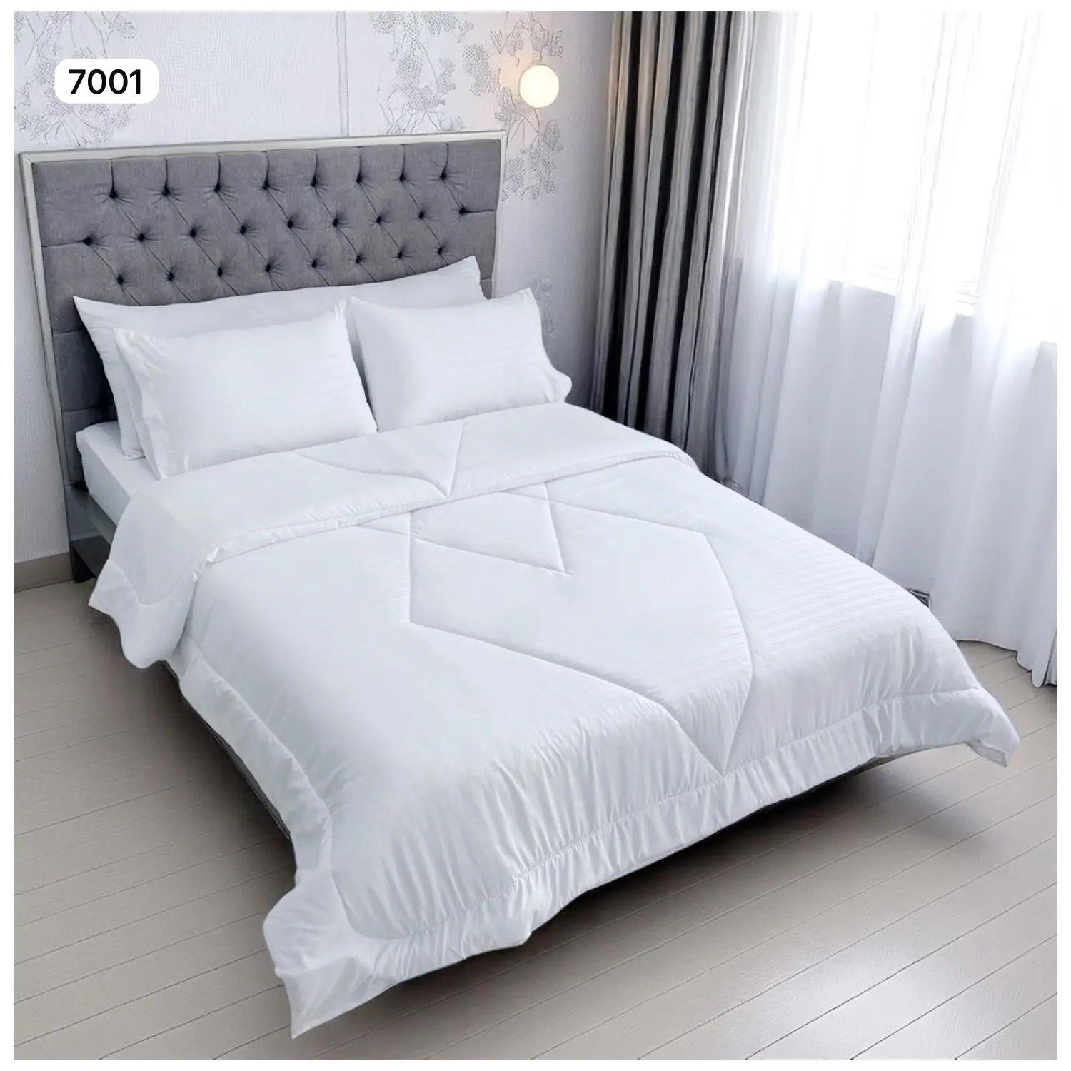 Edredón doble faz blanco para cama doble con diseño acolchado lineal y capitoné en cabecero gris.