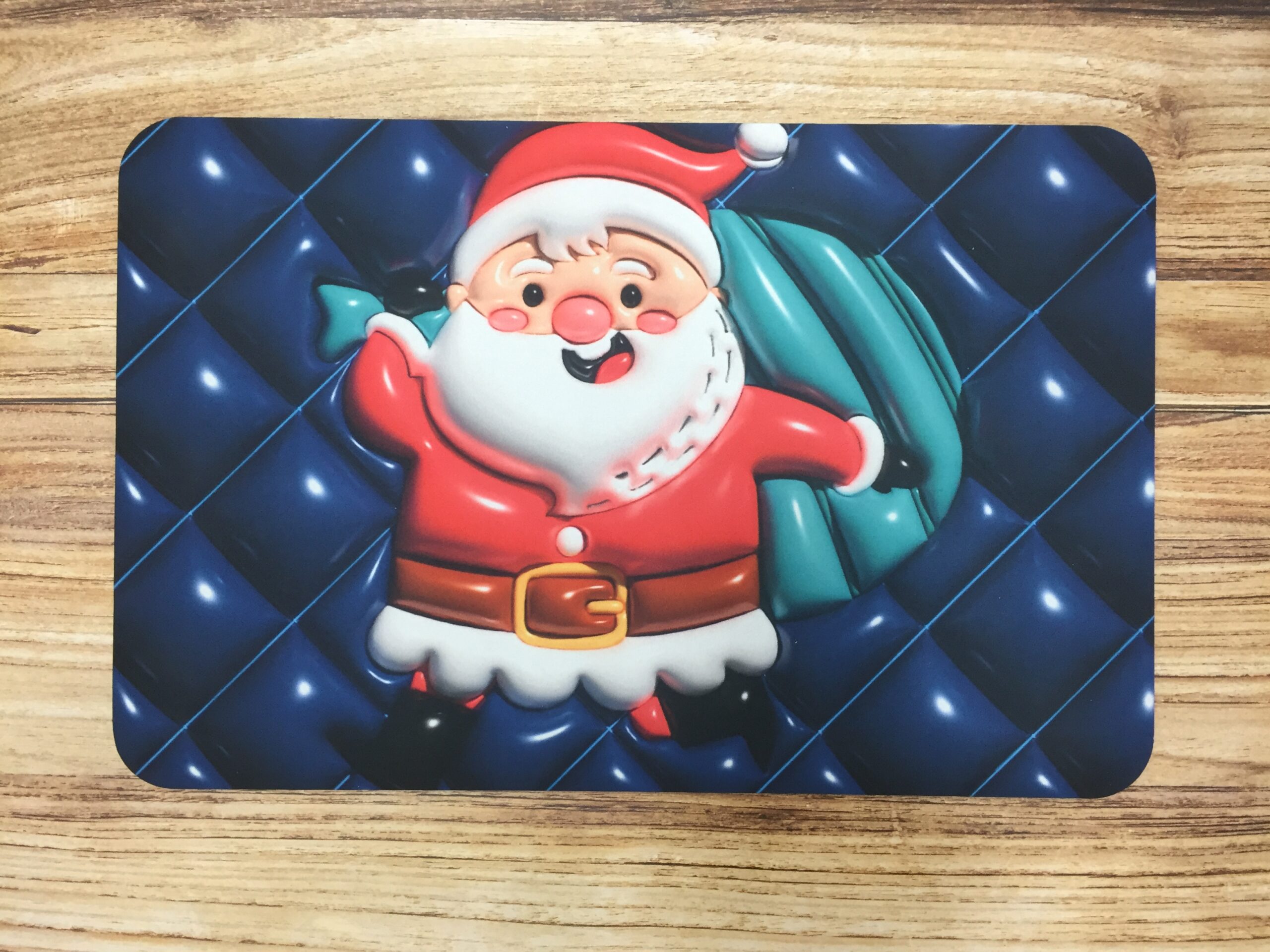 Tapete absorbente con estampado de Santa Claus sobre fondo azul acolchado, ideal para Navidad.