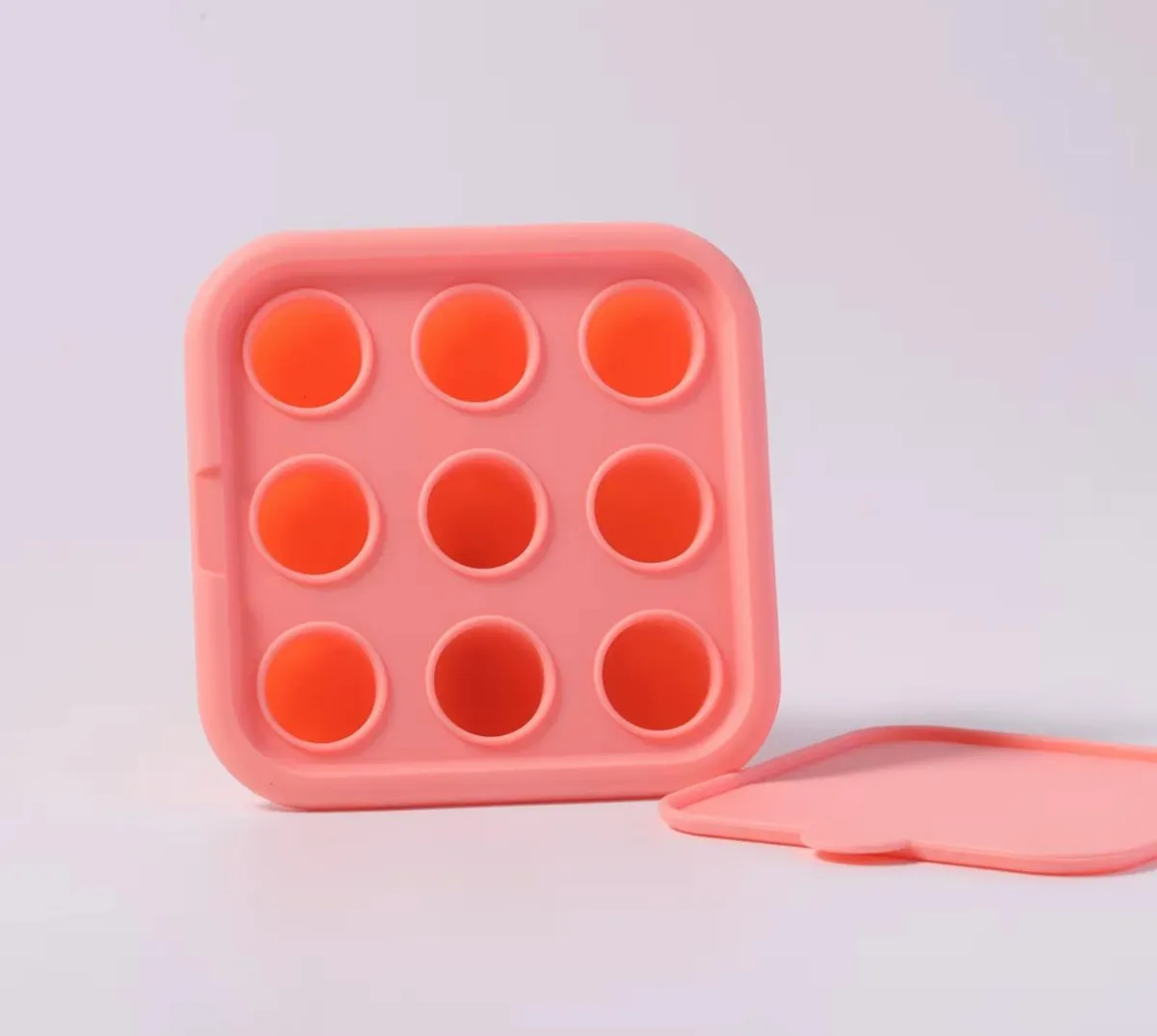 Set x2 chupones de fruta rosados, tipo pop it, con 9 burbujas y tapa a juego.