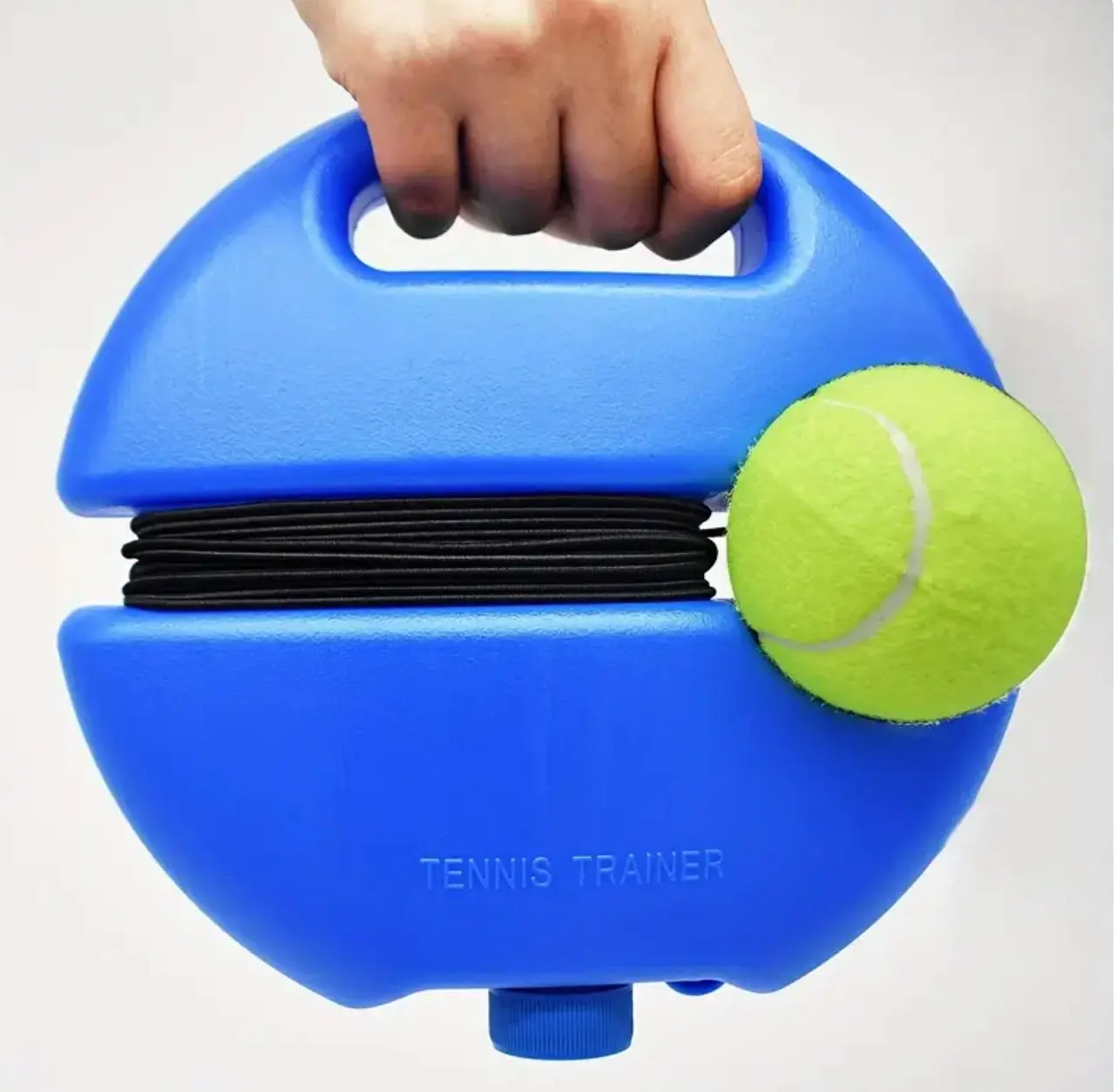 Entrenador de tenis azul con cuerda elástica y pelota, sostenido por mano.