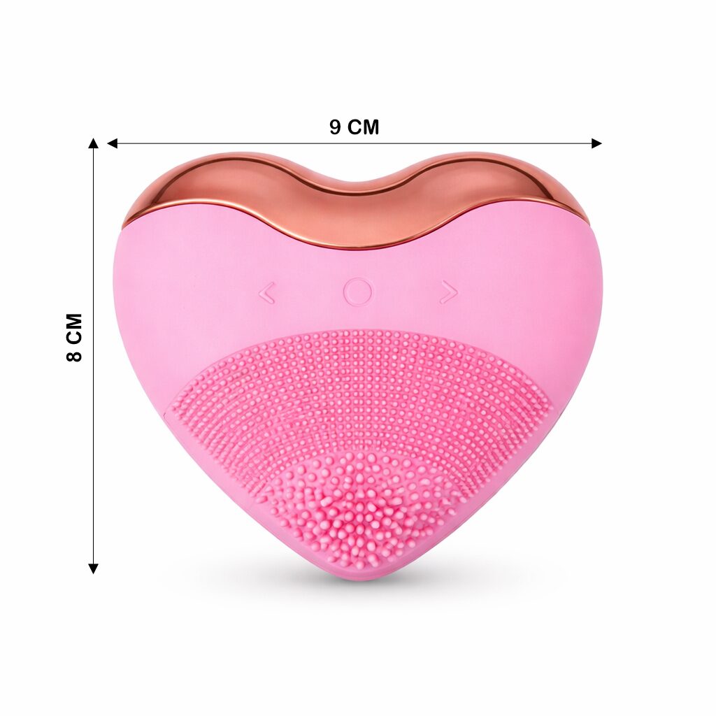 Limpiador facial rosa en forma de corazón, 9x8 cm, con cerdas suaves y detalle metálico cobre.