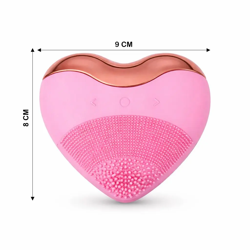 Limpiador facial rosa en forma de corazón, 9x8 cm, con cerdas suaves y detalle metálico cobre.