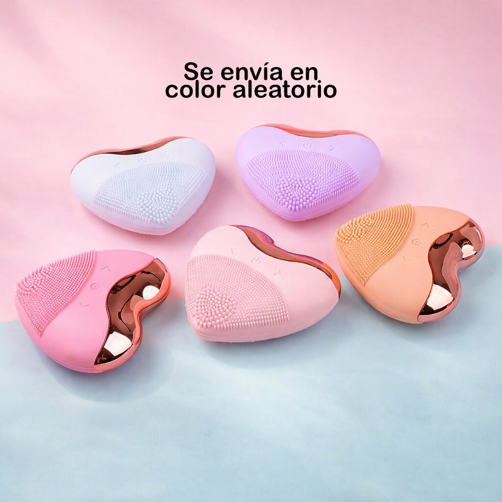 Limpiador facial eléctrico en forma de corazón, colores pastel: blanco, lila, rosa y naranja, con detalles dorados.